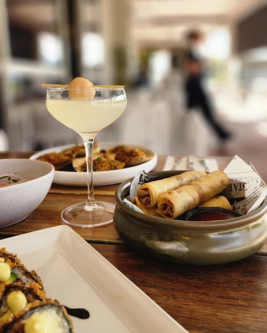 Share plates and a cocktail on a table in the dining room